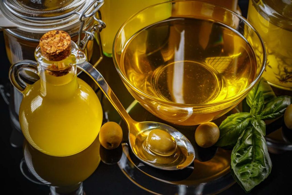 Composition of olive oil and green olives on clipping path background