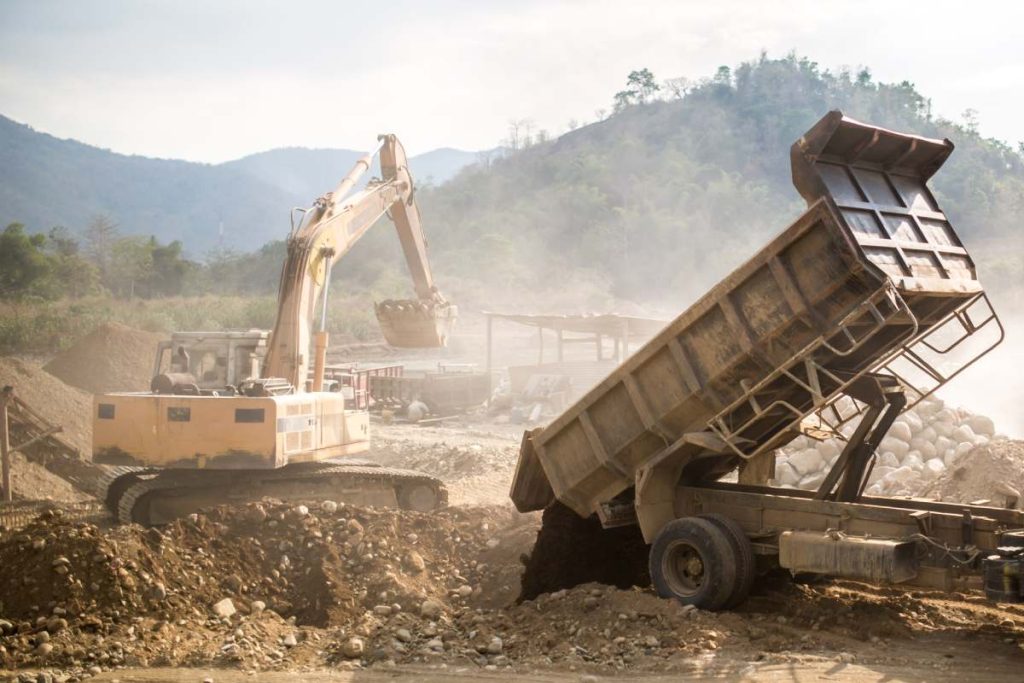 Heavy machinery such as excavator works at a quarry.