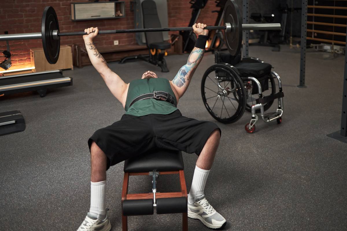 Man with Tattoo Lifting Weights in a Gym Setting
