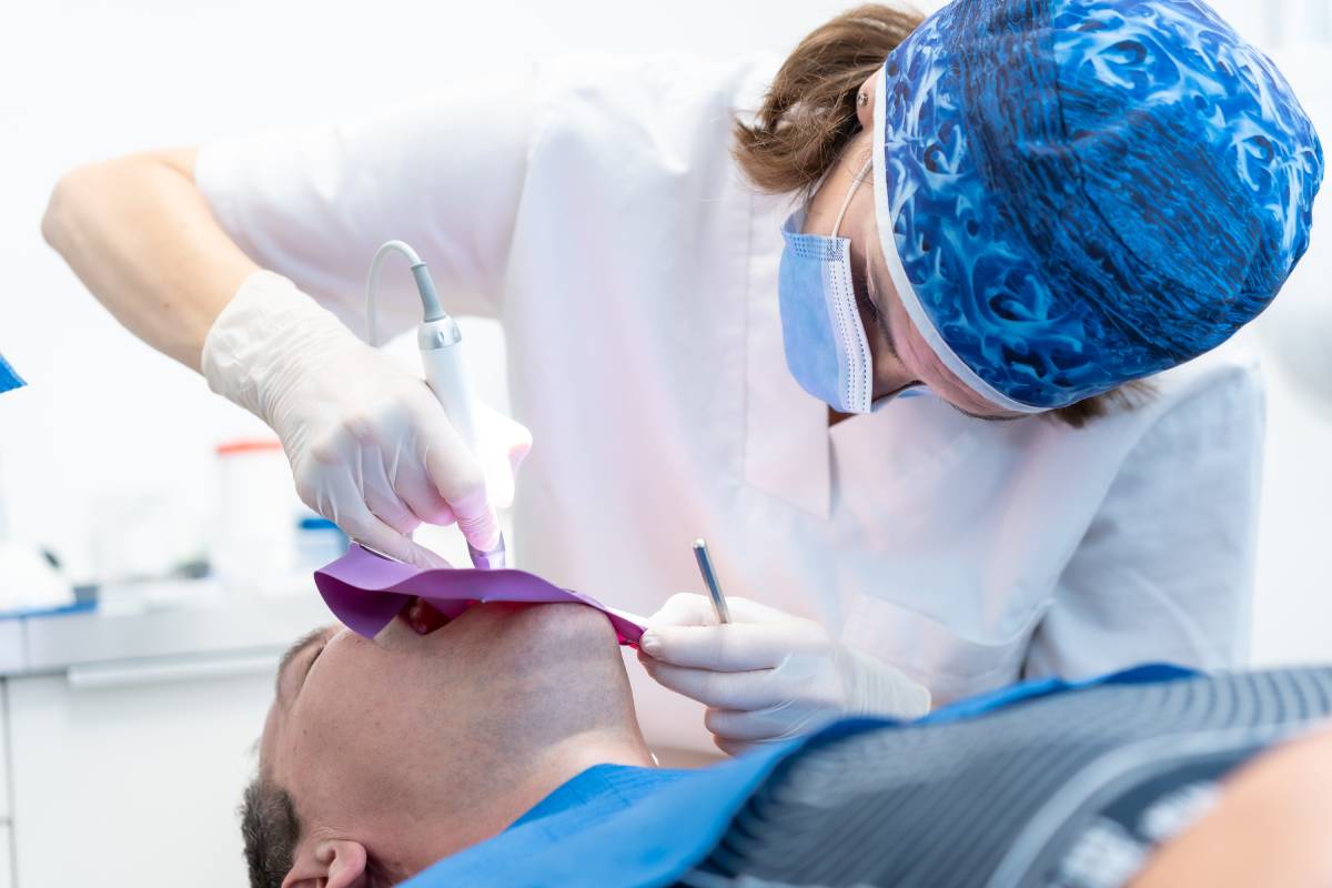 Dental clinic, a doctor performing a root canal to a patient in full operation Veneers